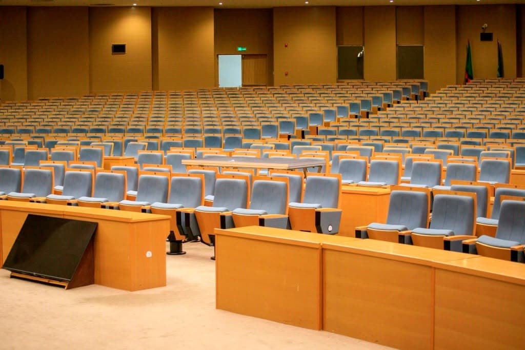 Modern conference chamber interior with tiered seating